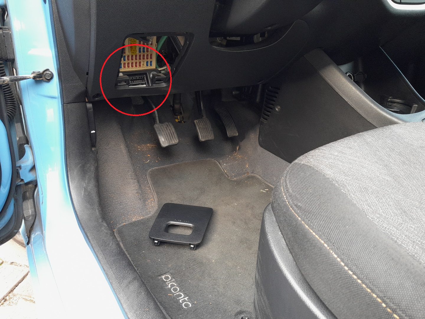 Kia Picanto 2011–2017 OBD-II diagnostic port behind fuse/relay panel marked FUSE OBD
