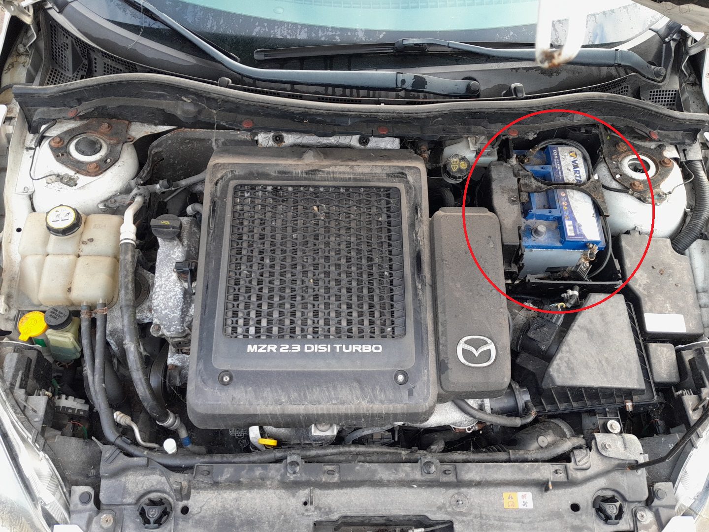 Mazda 3 2009–2012 12-volt battery location in the engine bay