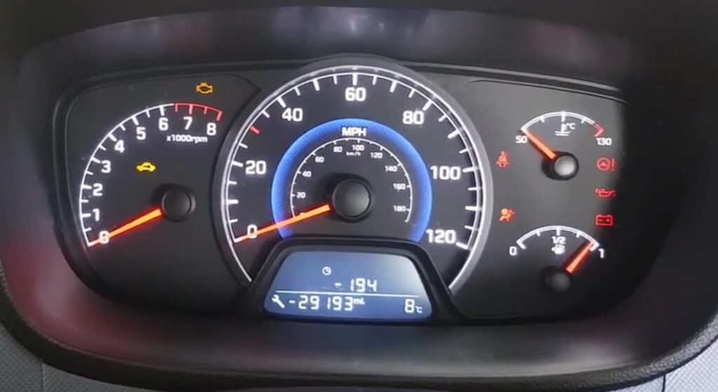 Hyundai i10 (IA, 2014-2019) instrument cluster showing the service spanner icon beside the trip/odometer LCD, where the service interval is reset