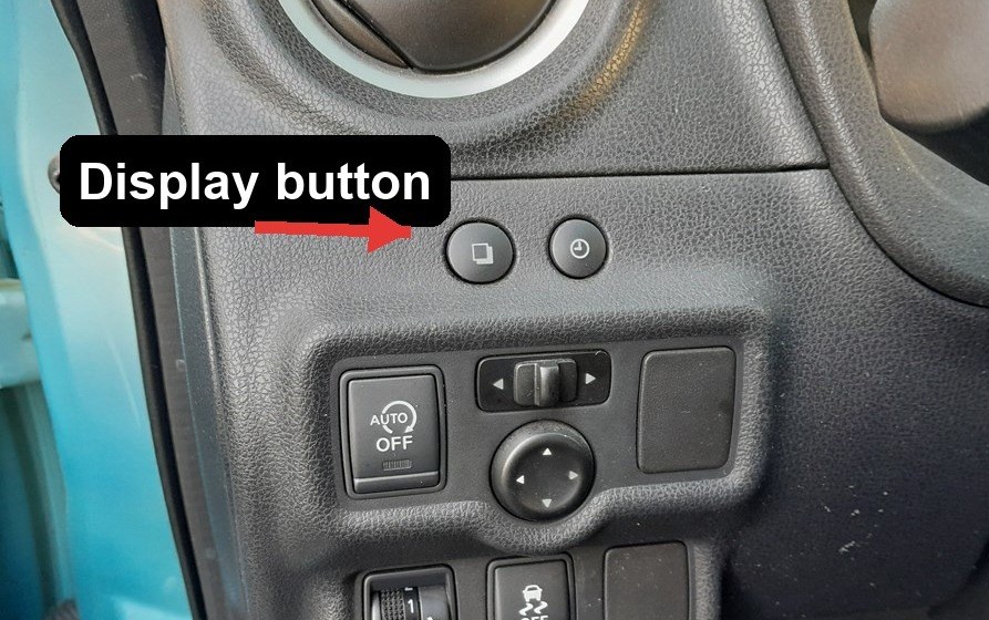Trip-computer display button on the Nissan Note E12 dashboard, used to reach the TPMS reset screen