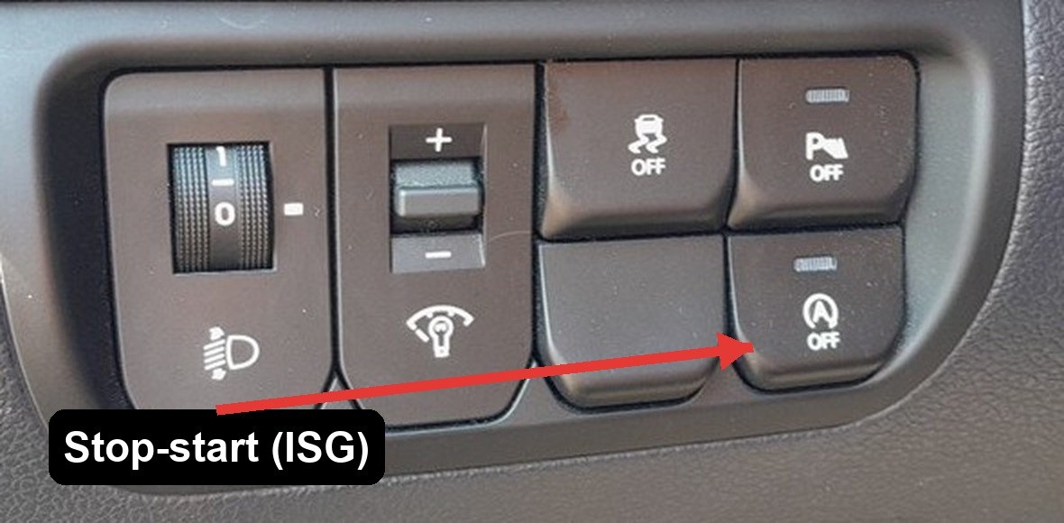 ISG stop-start OFF button on the driver's-side switch cluster of a Kia Rio Mk3, arrowed