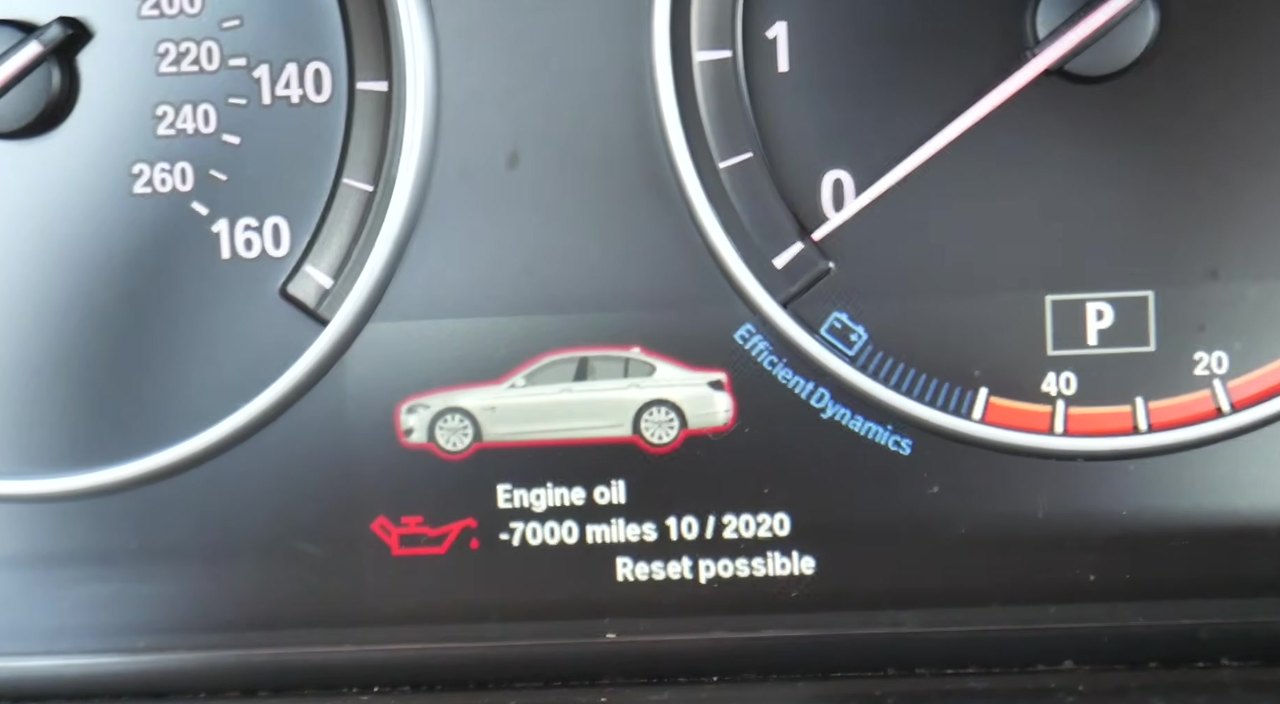 BMW 5 Series F10 instrument cluster showing the service indicator reset prompt