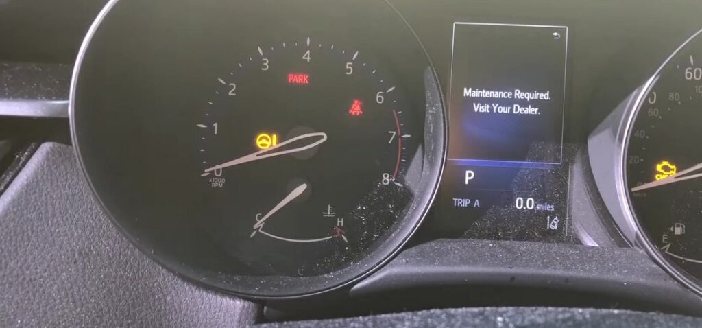 Toyota C-HR (XW10) instrument cluster showing the "Maintenance Required. Visit Your Dealer." message on the multi-information display before the service reset