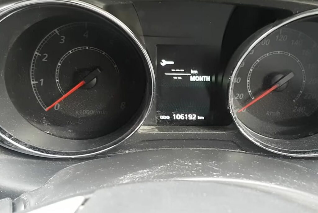 Mitsubishi ASX cluster showing the service month/distance display.
