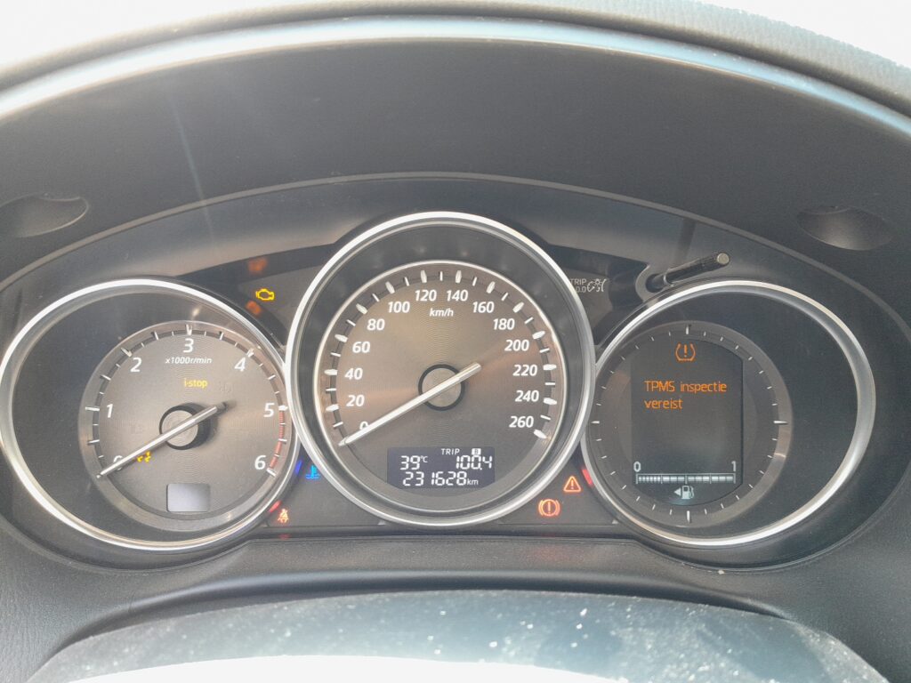 Mazda CX-5 Mk1 (KE) instrument cluster showing the trip and warning displays.