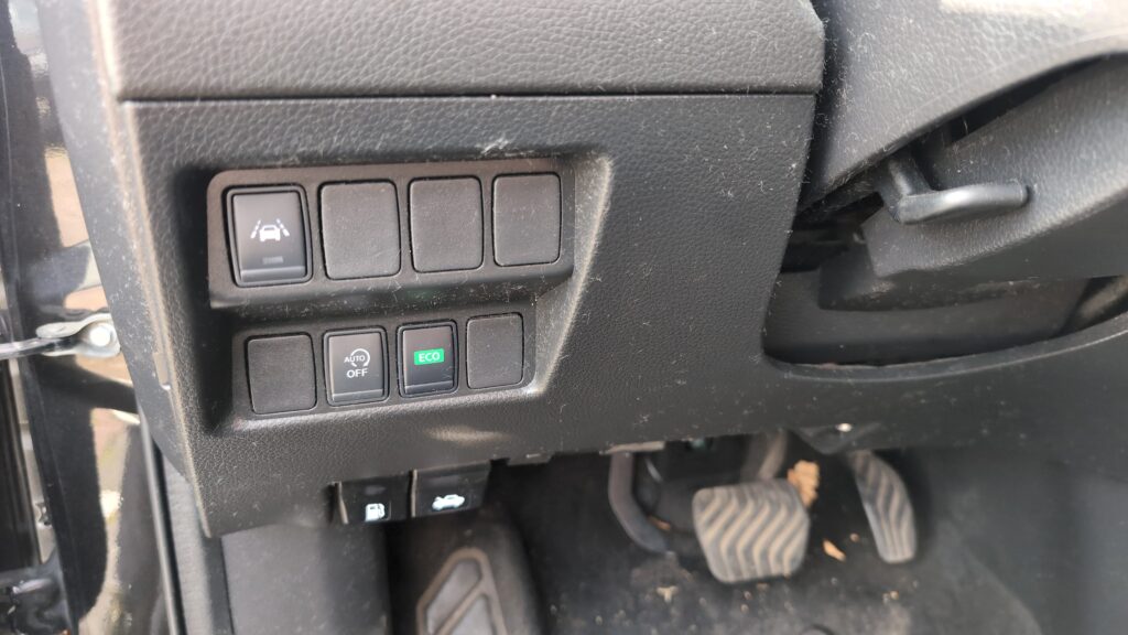 Nissan Qashqai Mk2 J11 dashboard with ECO Stop/Start button visible on the centre console