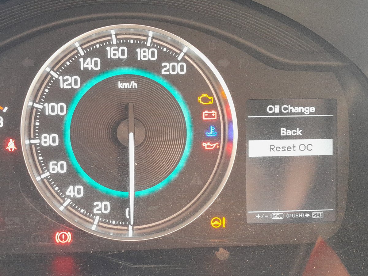 Suzuki Ignis instrument cluster showing the Oil Change and Reset OC menu