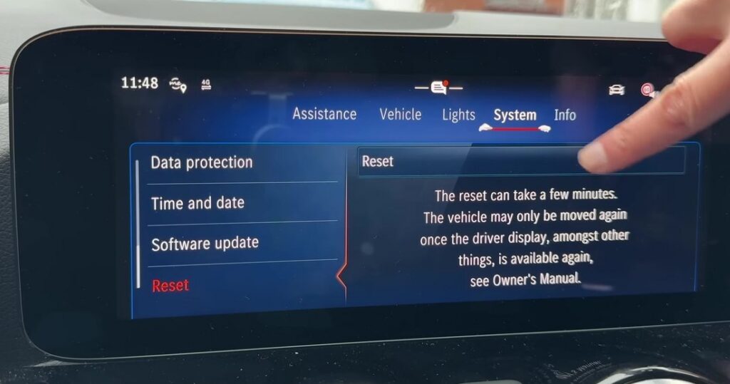 Mercedes MBUX System menu with Reset highlighted, showing the reset confirmation text.