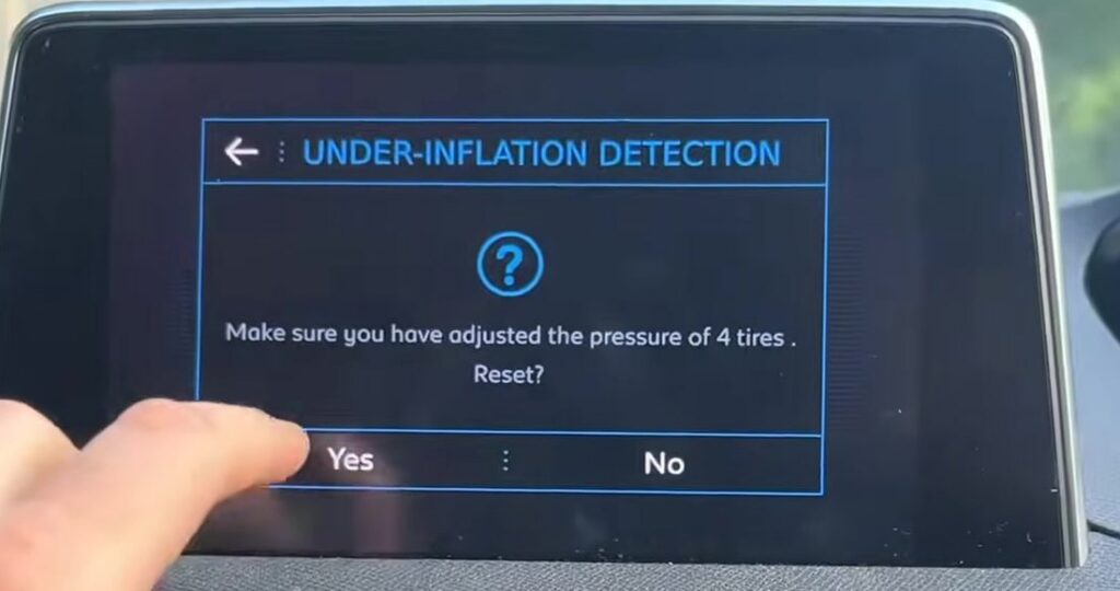 Peugeot 5008 touchscreen showing the under-inflation detection tyre pressure reset prompt