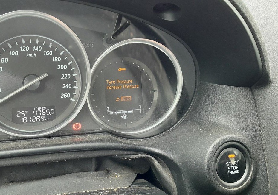 Mazda CX-5 cluster display showing the tire pressure warning