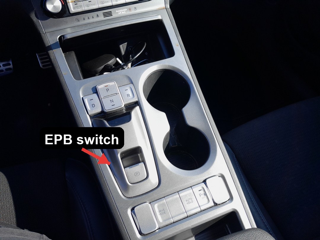 Hyundai Kona electronic parking brake EPB switch below the centre-console shifter