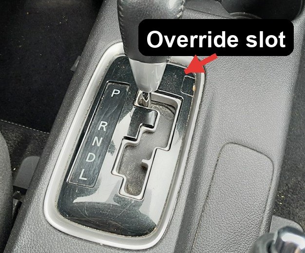 Shift-lock override slot beside the selector on a Mitsubishi Outlander