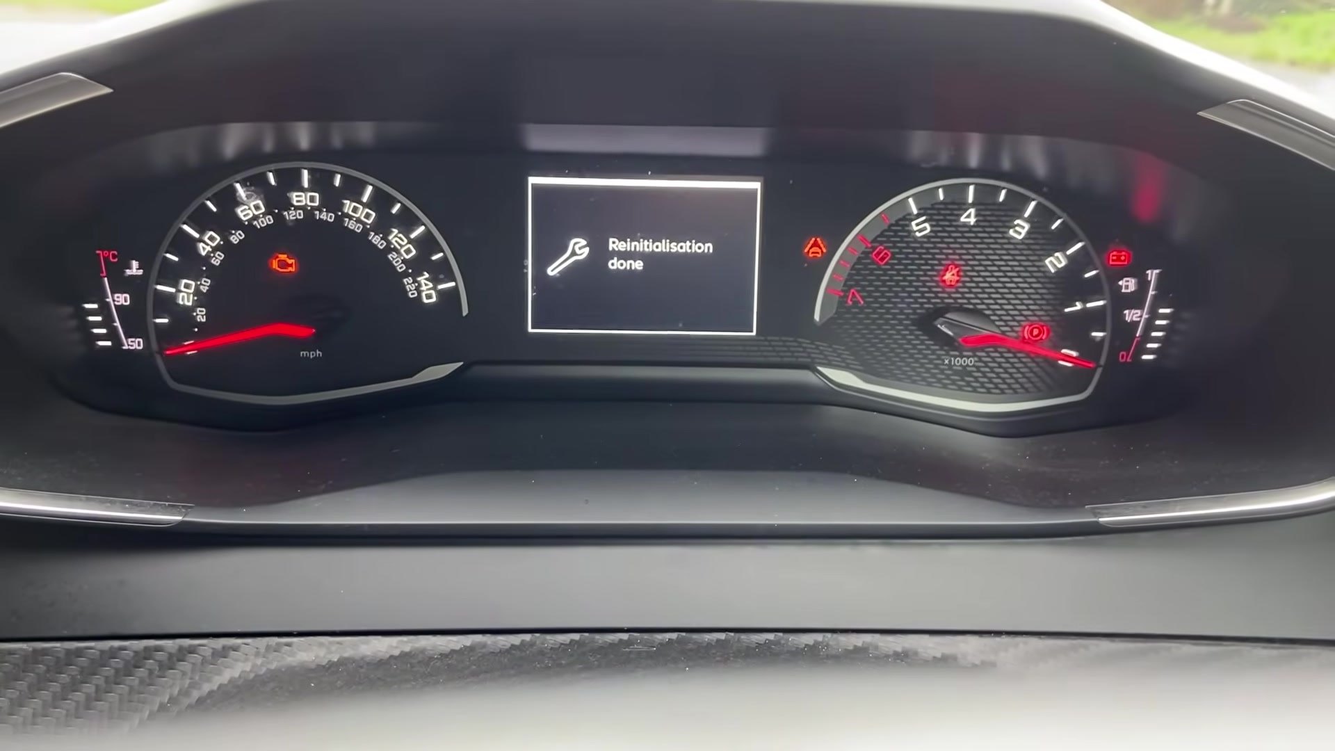 Peugeot 208 Mk2 cluster showing a wrench icon and 'Reinitialisation done' confirming the service reset completed.