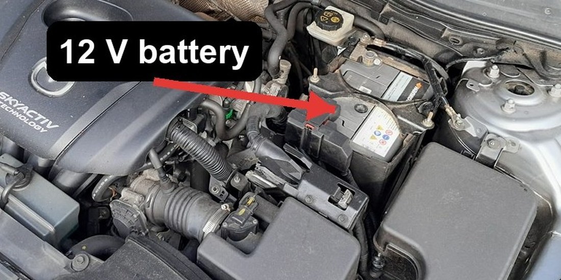 Mazda 3 (BM) 12 volt battery location in the engine bay