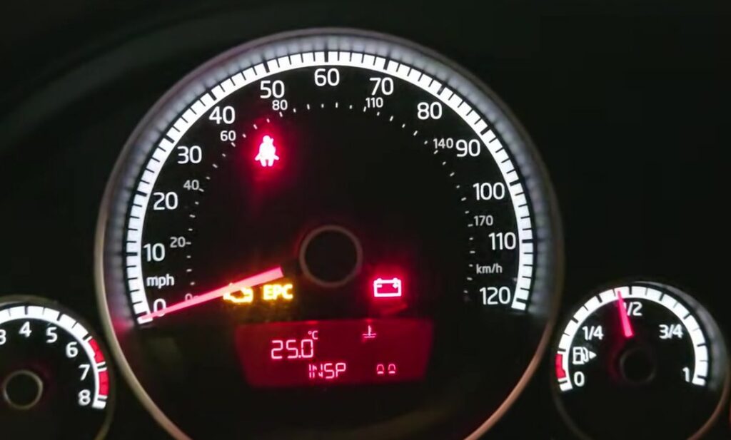 Volkswagen Up instrument cluster showing the INSP inspection service reminder in the display.