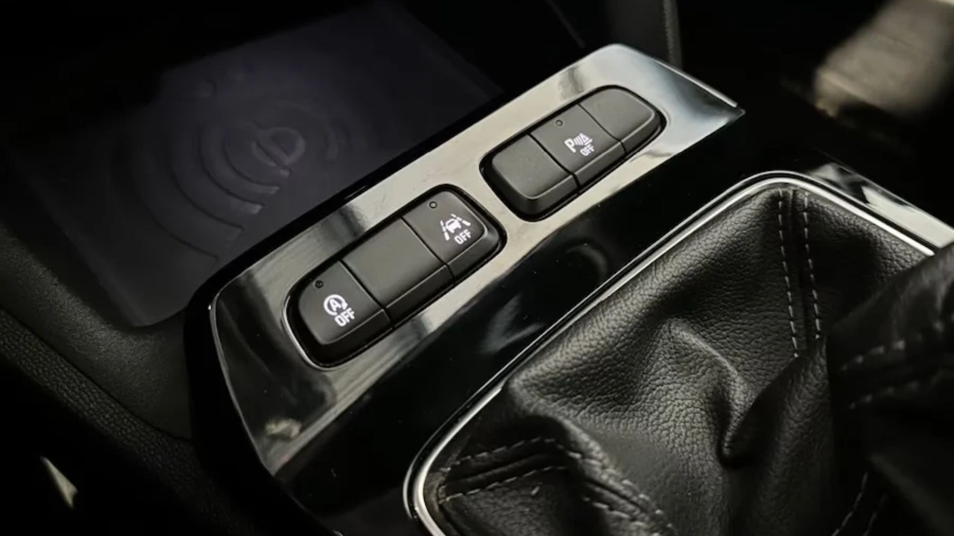 Vauxhall Mokka Mk2 centre-console button cluster: the A OFF Stop-Start button (marked with an A in a circle), with the lane-keep and ESP buttons and the wireless charging pad above.