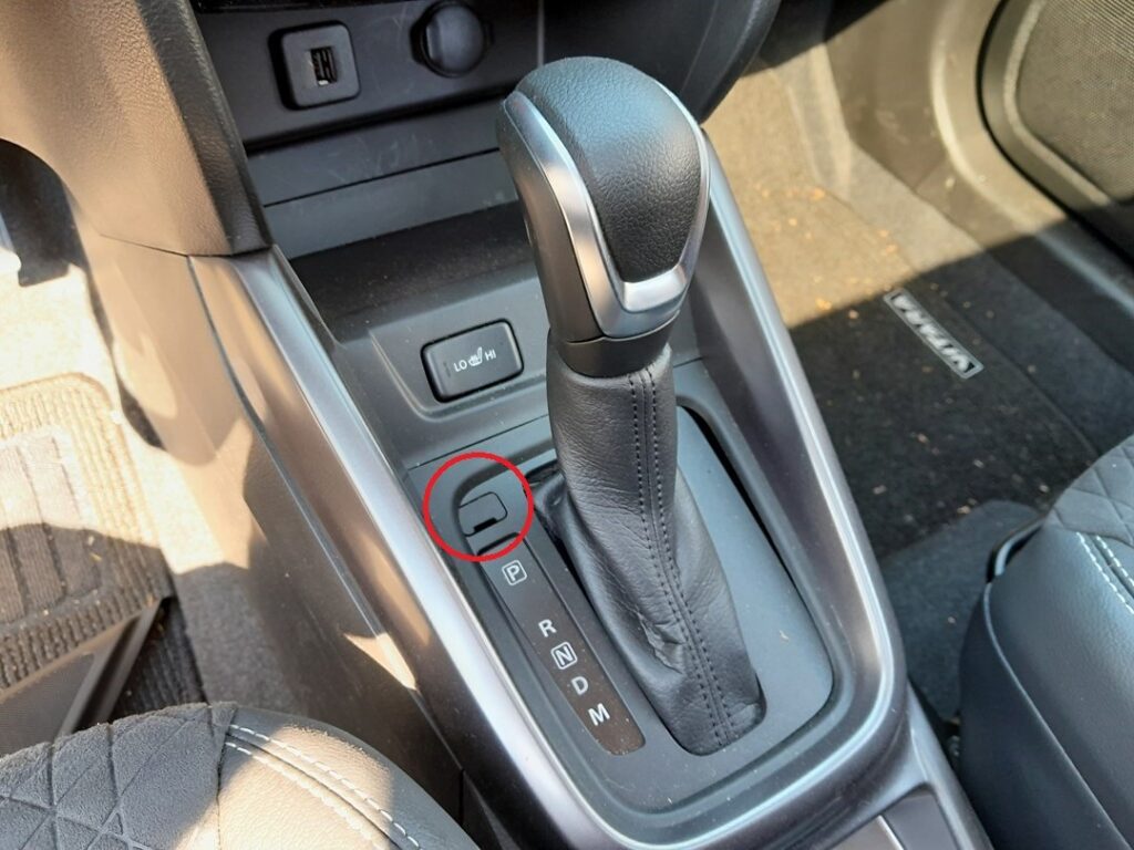 Shift-lock release slot beside the gear selector on an automatic Suzuki Vitara (LY)