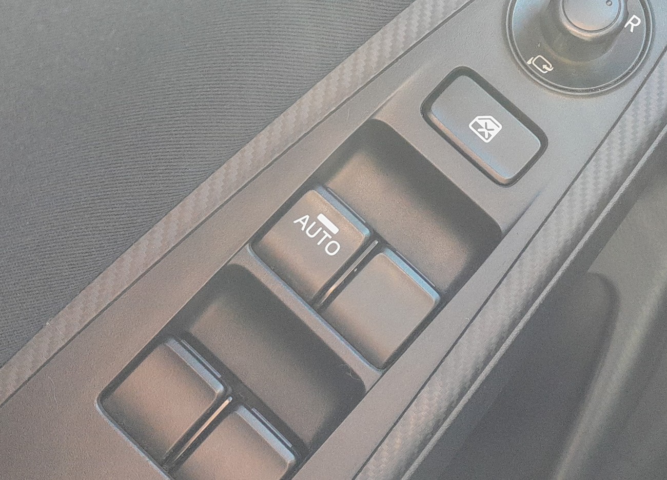 Driver door power-window switch panel on a Mazda 2 DJ