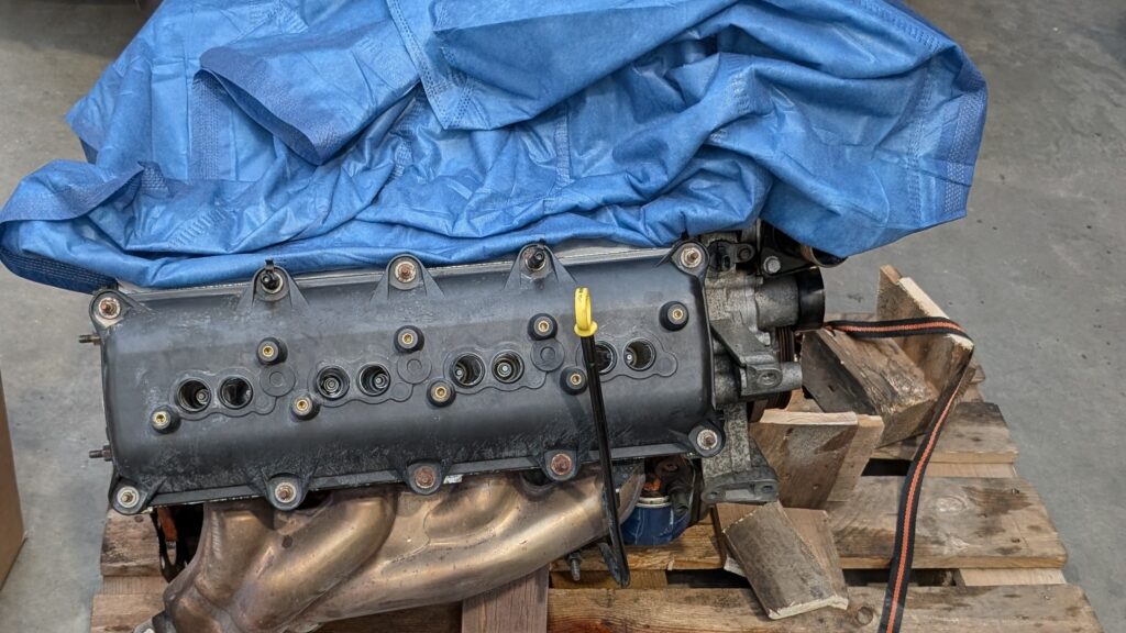 One cylinder bank of a 6.1 HEMI V8 on a pallet with the spark-plug holes visible
