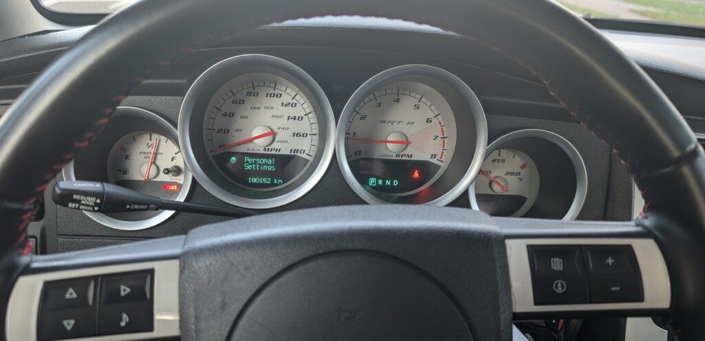 Instrument cluster EVIC showing the Personal Settings menu, with the steering-wheel menu buttons, on a Dodge Charger SRT8