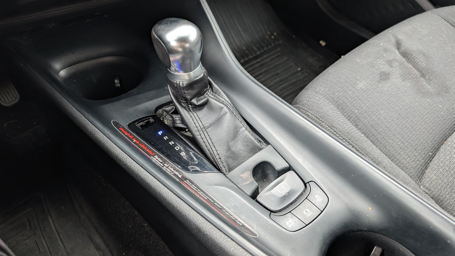 Toyota C-HR Mk1 centre console with the electronic parking-brake switch, Brake Hold and drive-mode buttons