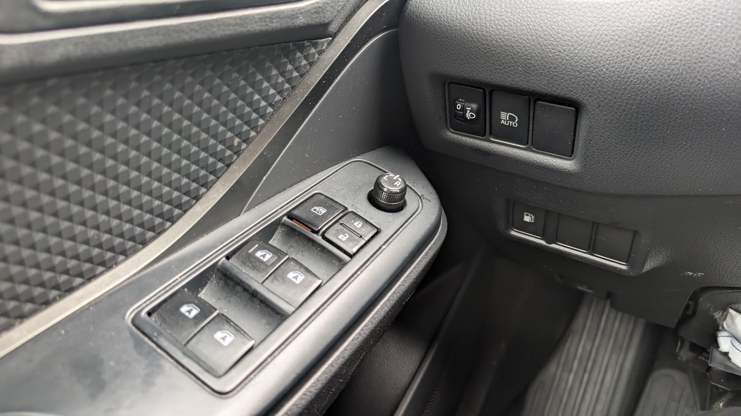 Toyota C-HR Mk1 driver door switch panel with the power-window switches