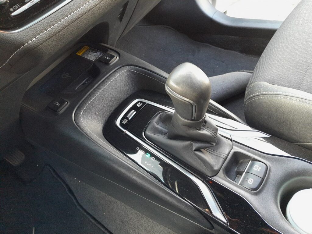 Electronic parking brake switch and brake-hold button on the Toyota Corolla Mk12 (E210) console