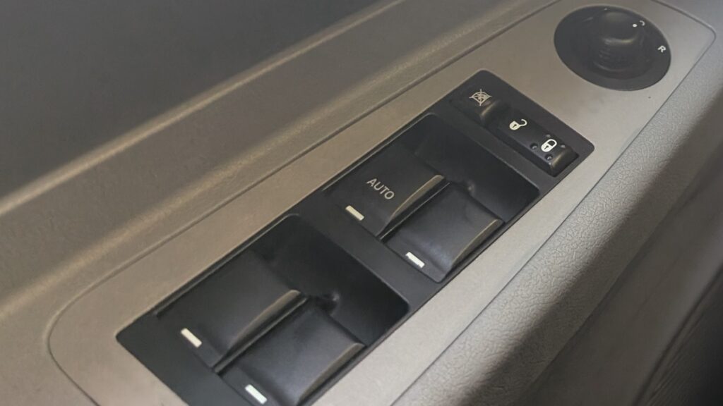 Driver door power window switch pack with the AUTO one-touch switch on a Dodge Charger LX