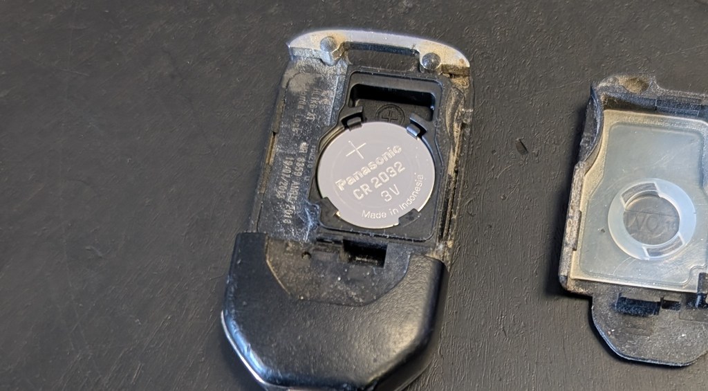 Honda Civic (FK) remote key opened showing the Panasonic CR2032 coin cell