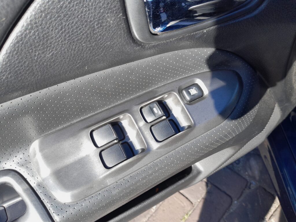 Driver's door window switch panel on the Mitsubishi Lancer Mk7 (CS).