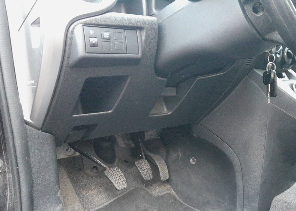 Mazda 2 DE OBD-II diagnostic port location under the driver-side dash