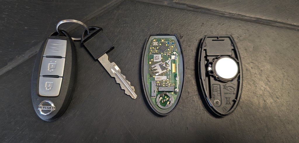 Nissan Juke (F16) Intelligent Key disassembled, showing the CR2032 coin cell and emergency blade