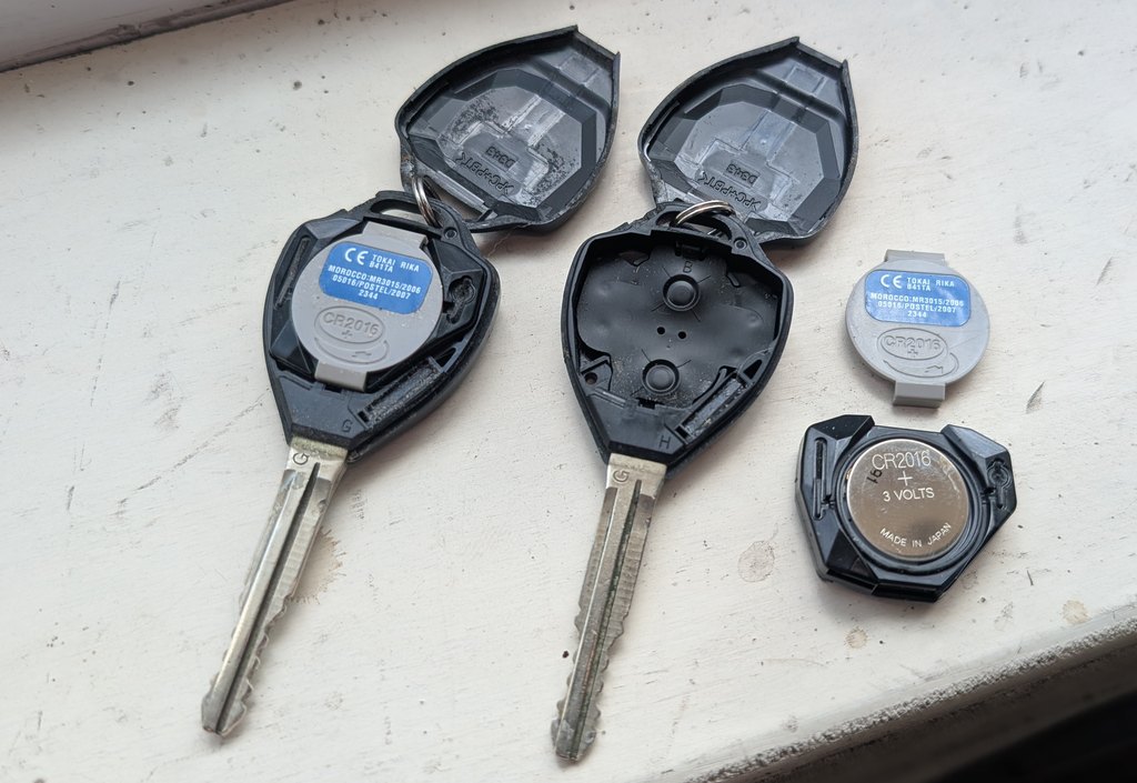 Toyota iQ remote key opened showing the CR2016 coin cell
