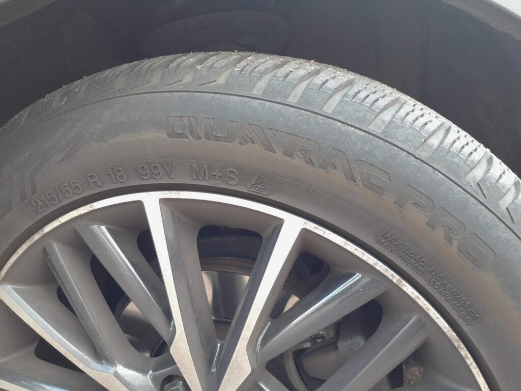 Tyre sidewall showing speed rating V on a 215/55 R18 99V tyre