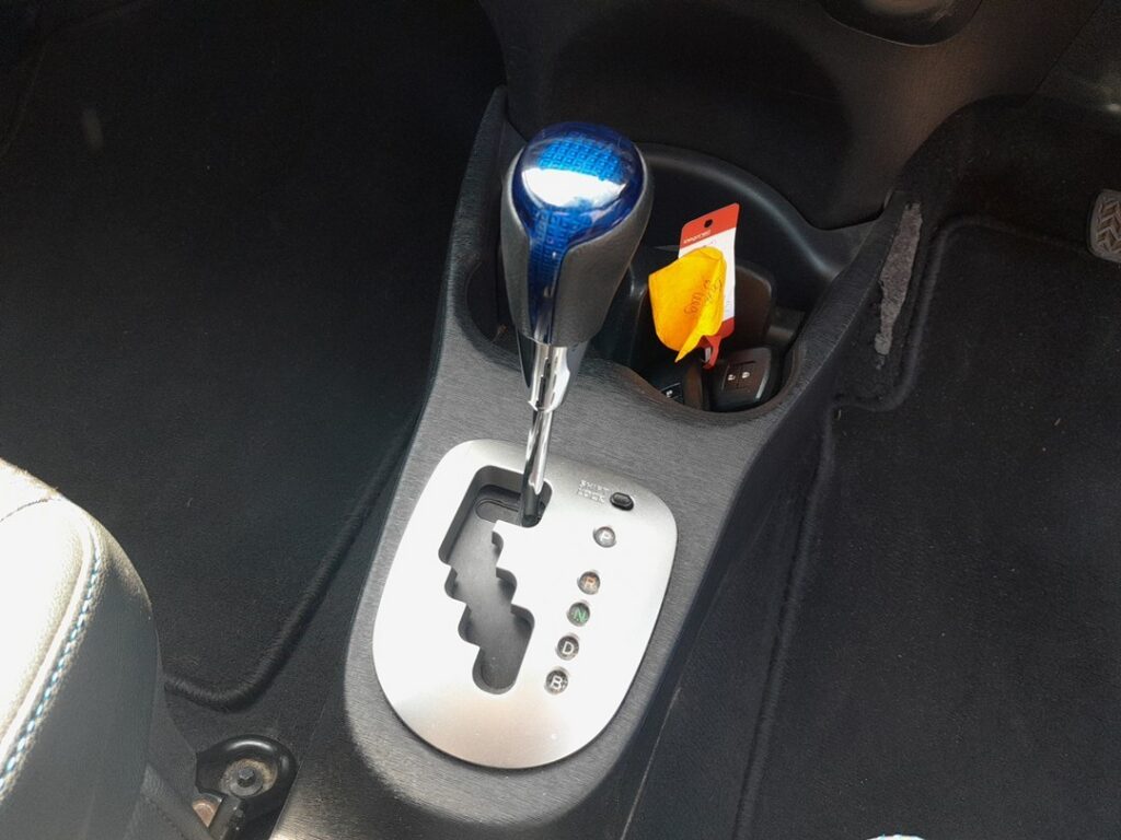 Shift-lock override button beside the gear selector on the Toyota Yaris Mk3 Hybrid