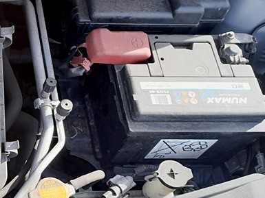 Toyota Aygo engine-bay battery with the red positive terminal cover