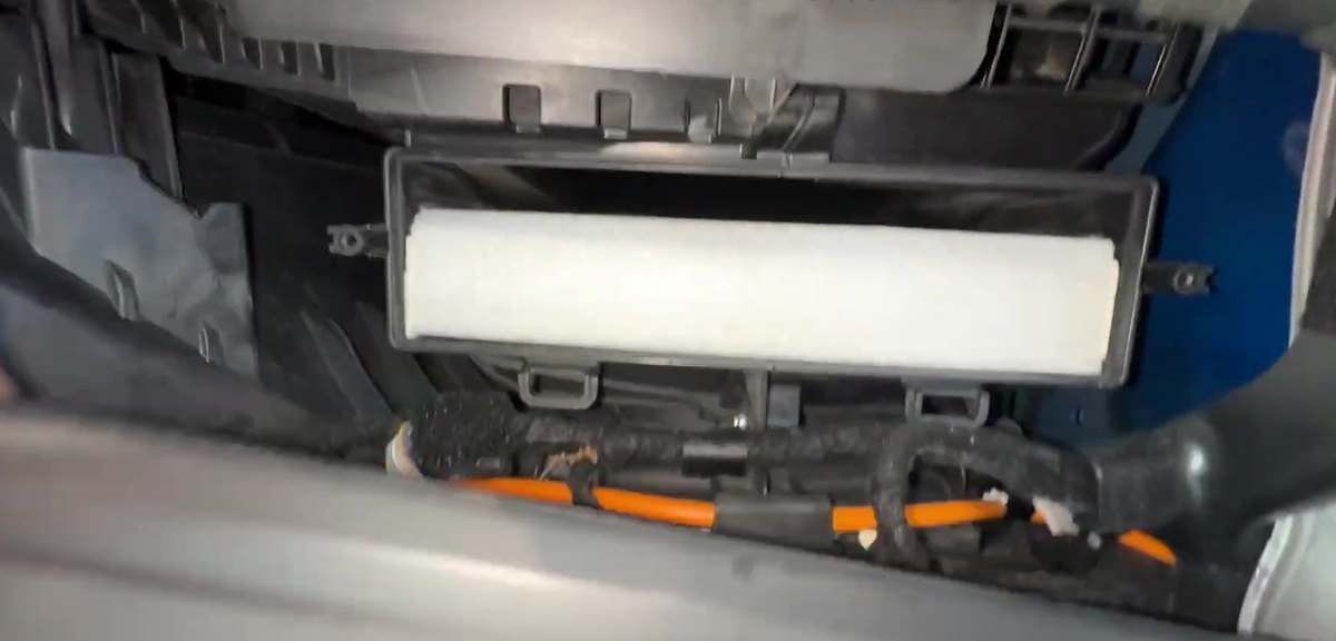 Ford F-150 P702 cabin air filter seated in its housing behind the glove box