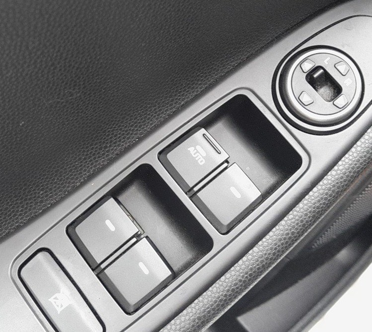 Hyundai i20 driver door power window switch marked AUTO