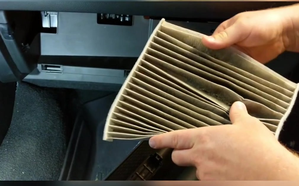 Old cabin air filter pulled from the slot behind the glove box on a RAM 1500 DT