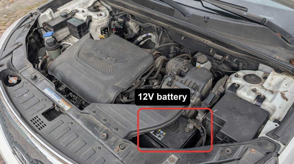 Kia Sorento XM 12V battery in the engine bay under the air intake