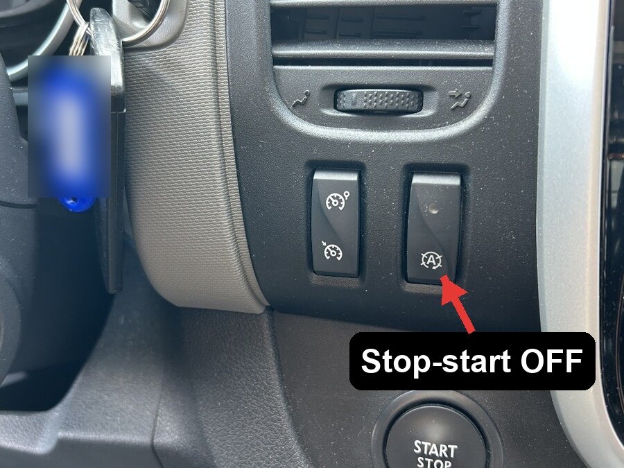 Stop-start off button on the van dashboard, marked with an A inside a circular arrow
