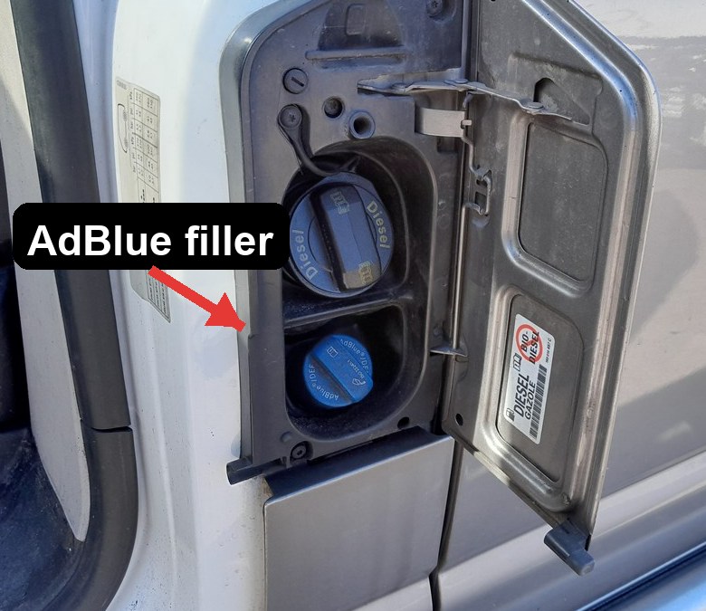VW Transporter T6 AdBlue filler with blue cap next to the diesel filler behind the fuel flap