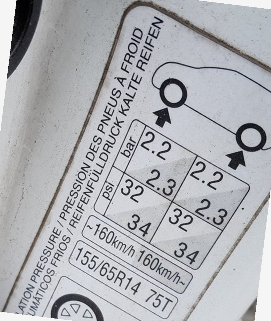 Toyota Aygo door-pillar tire pressure placard showing 155/65 R14 at 2.2 bar front and rear