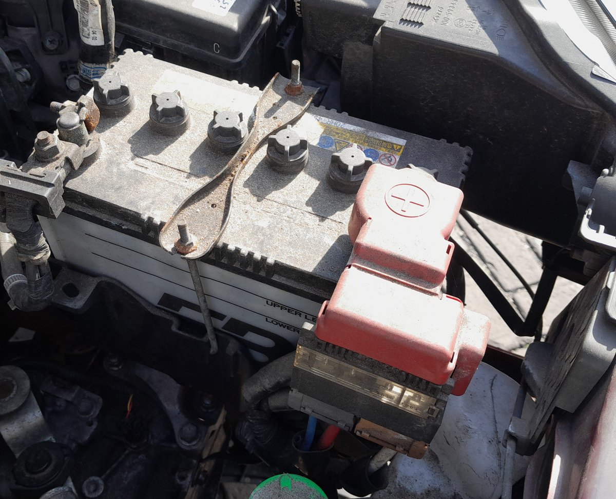 Suzuki Ignis 12V battery in the engine bay with red positive terminal cover