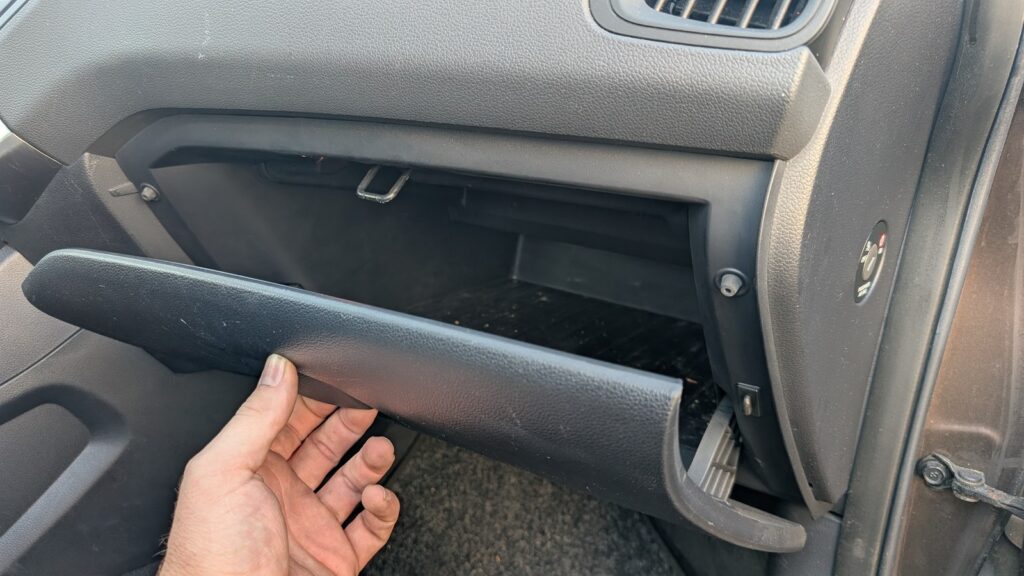 Glove box lowered on a Kia Rio Mk3 to reach the cabin air filter behind it